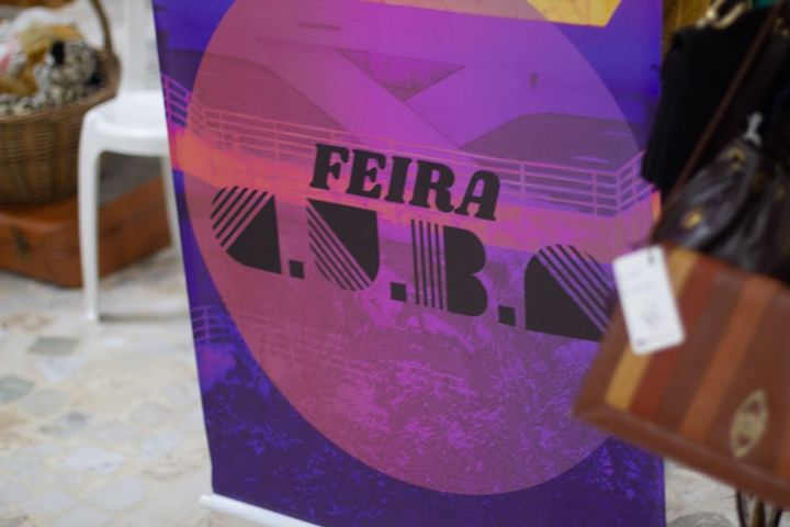Cartaz roxo da Feira C.U.B.A (maio)